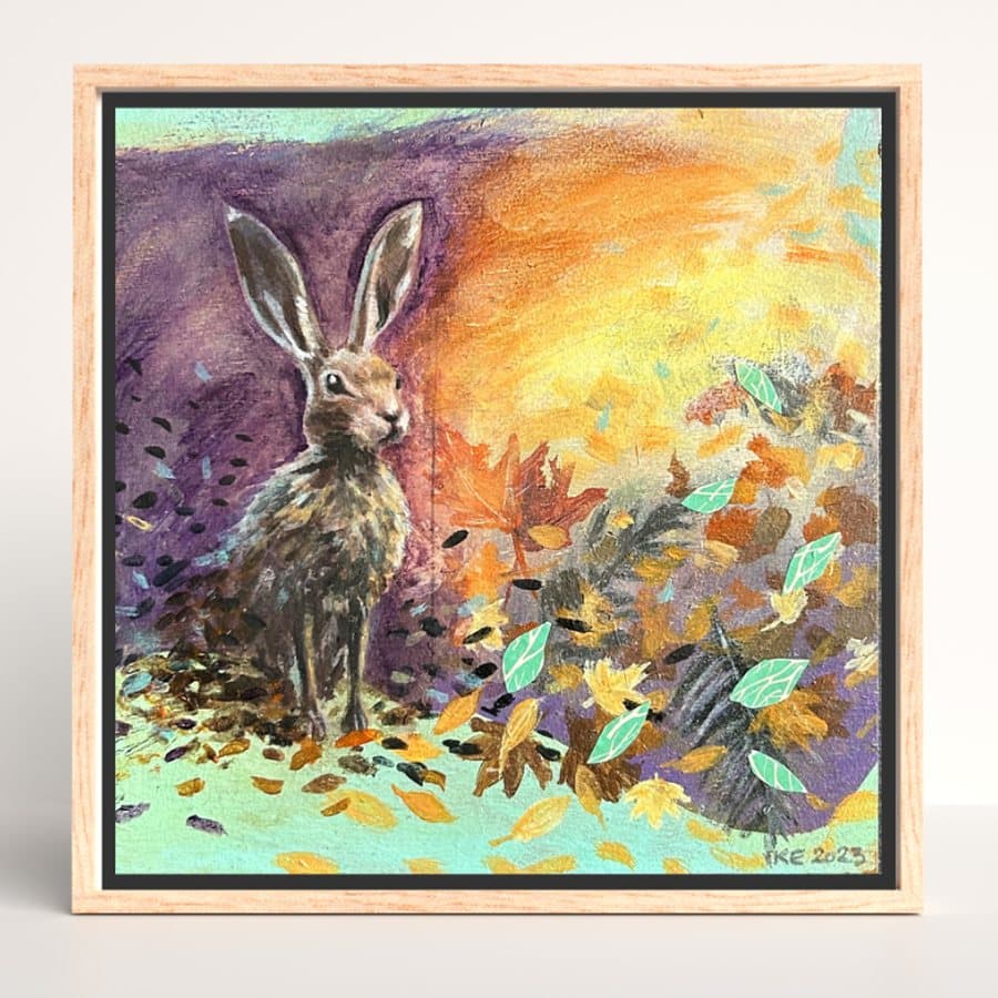 Framed Missed Beyond Measure painting of a hare among autumn leaves, standing upright on a shelf